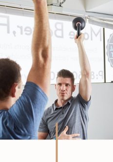 Chiropractor Dr Glenn Stevens Helping Male Client at The Functional Movement Club in Brookvale, Sydney
